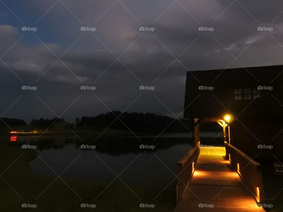 Cabin on the lake against the night sky