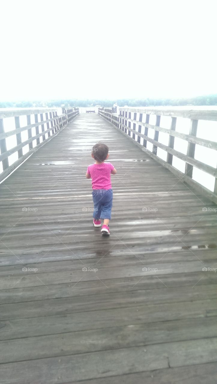 walking little girl . on the river 