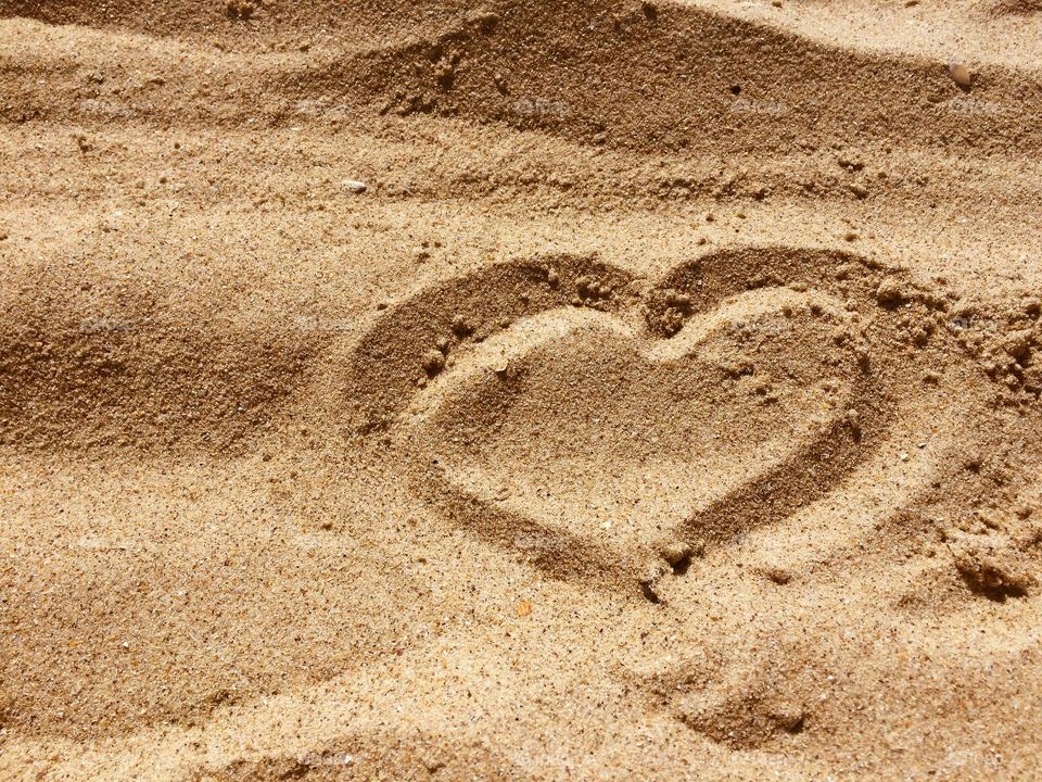 Love sign on a sand