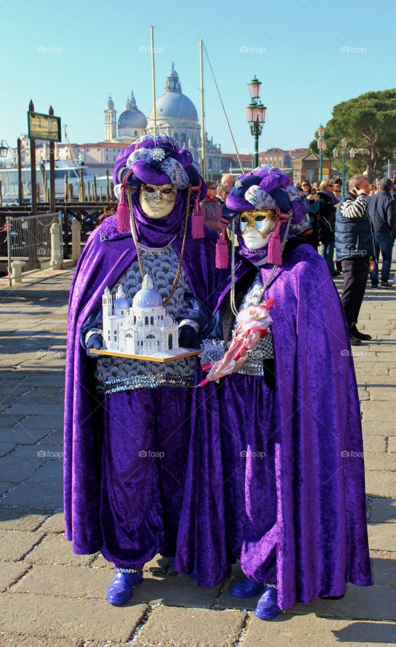 Couple pose with their replica of the Santa Maria della Salute. The real basilica is behind them in the background.