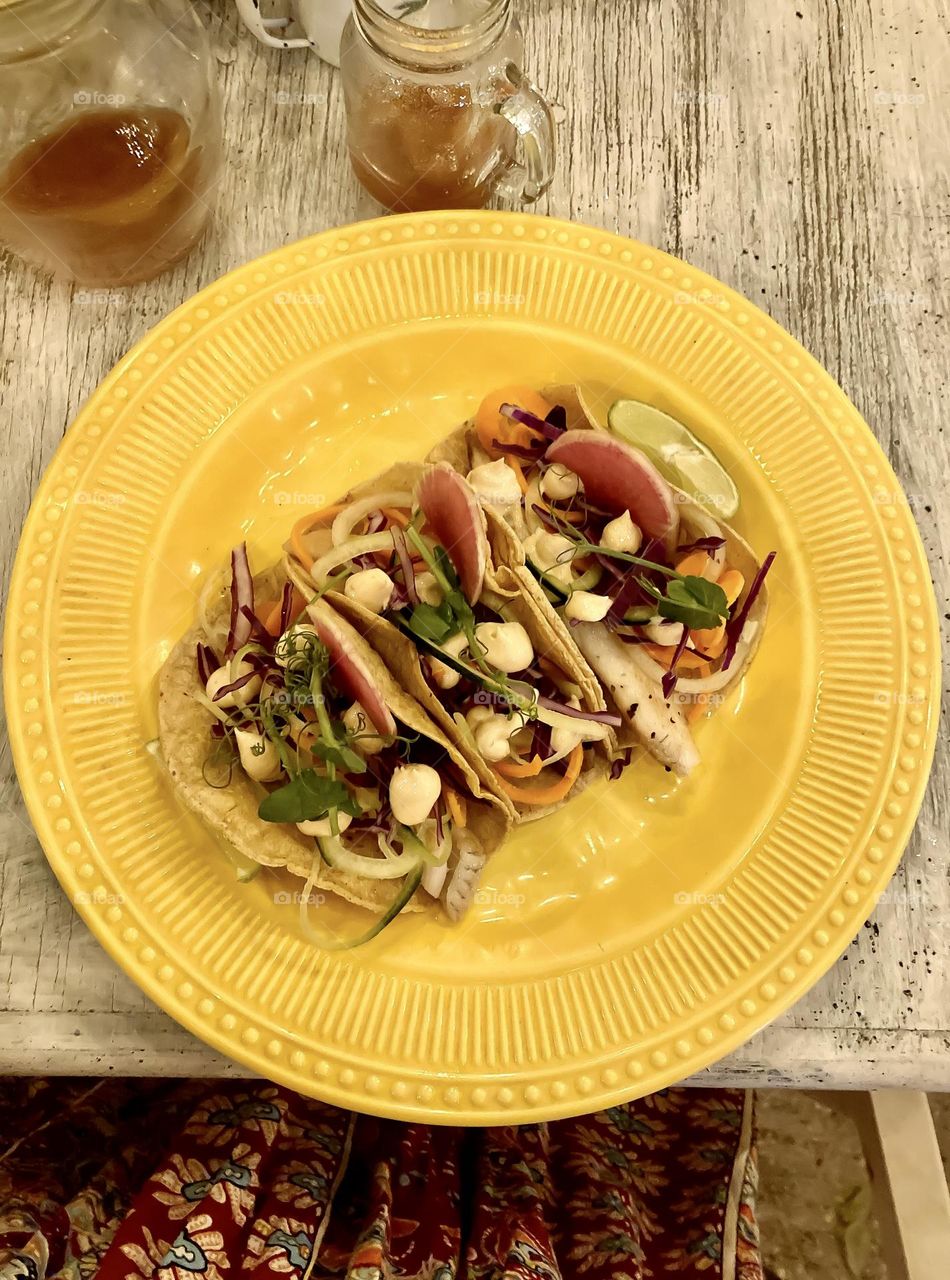 Amazing fish tacos with red cabbage, carrots, cucumber, cilantro and chipotle mayo.