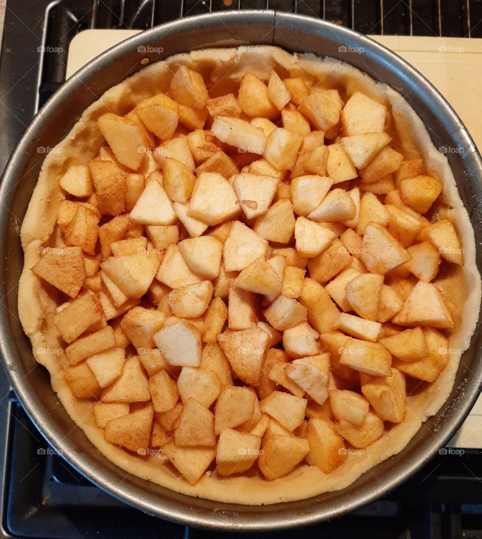 preparing apple pie, just before it goes into the oven