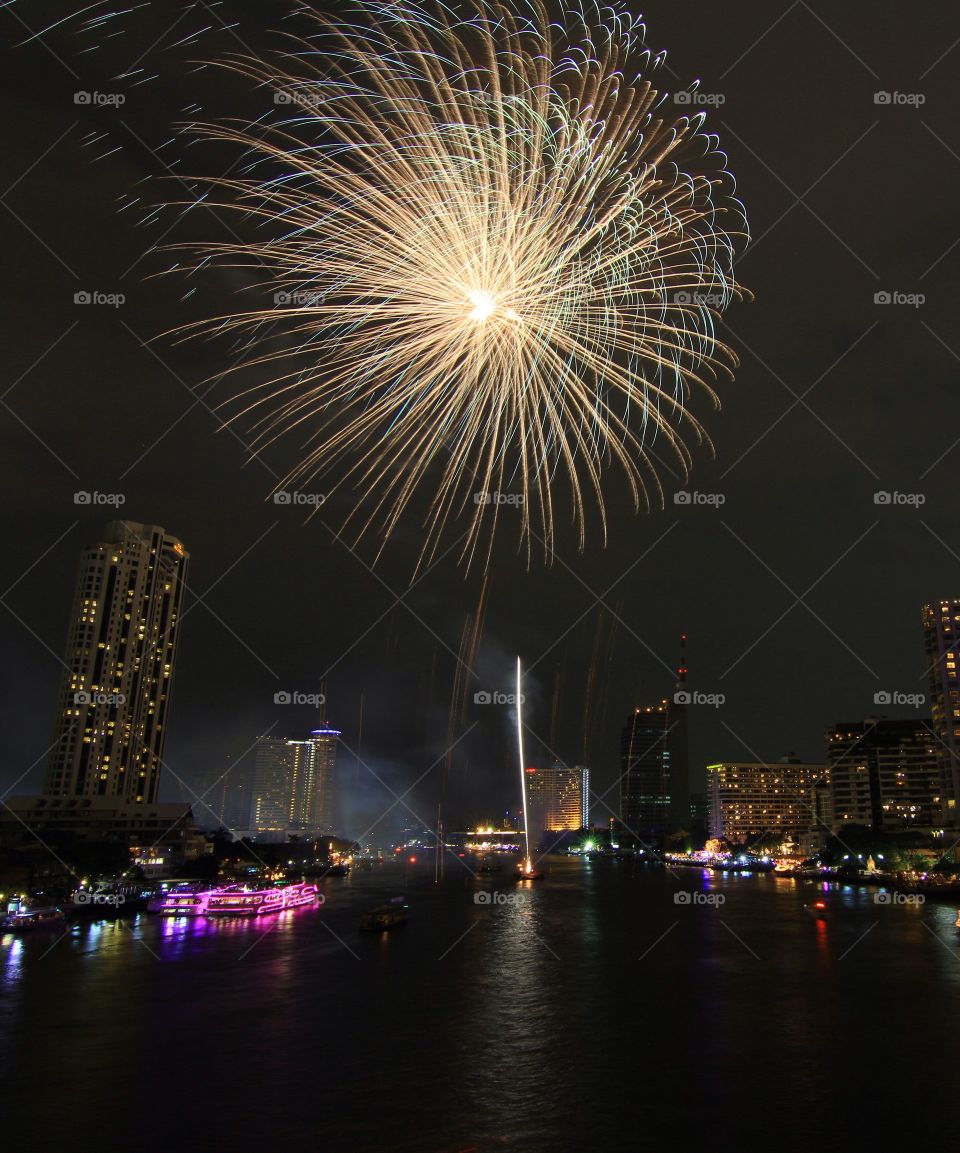 Firework display in city at night