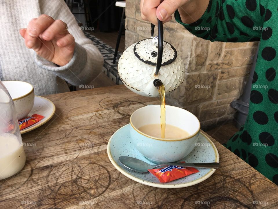 A cup of tea poured from a cute little tea pot ☕️