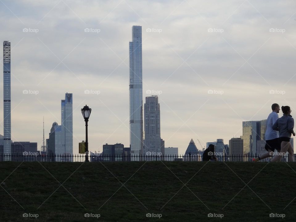 Men and women jog around at reservoir 