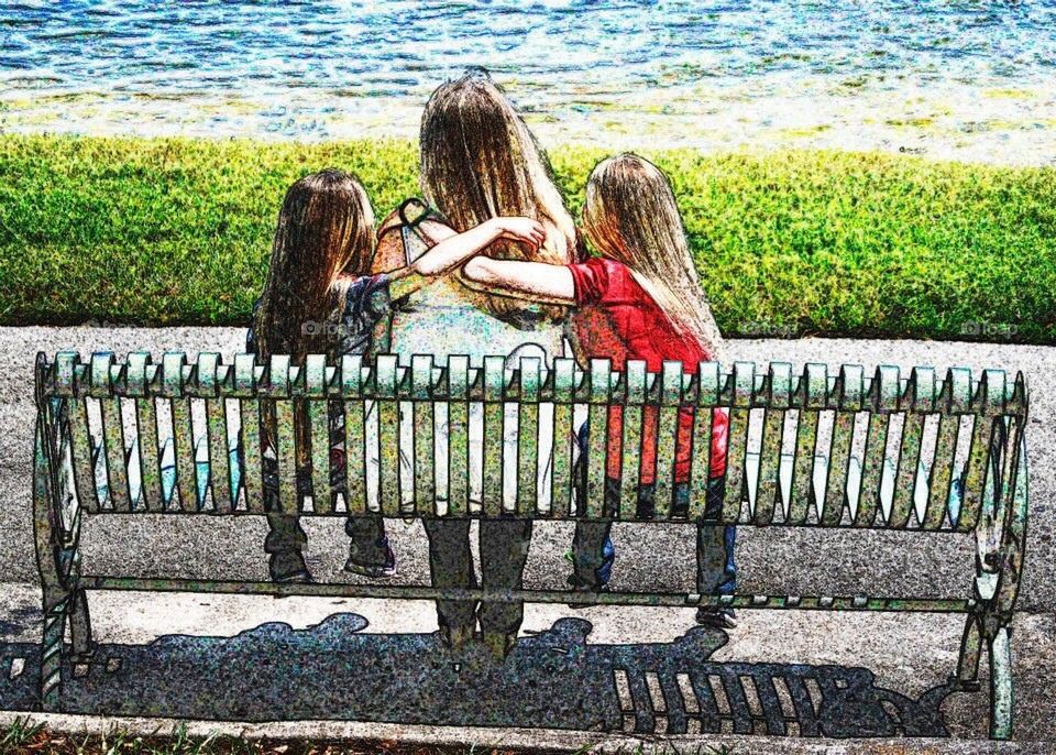 Mommy and  her girls. Mothers and daughters sitting in a bench 