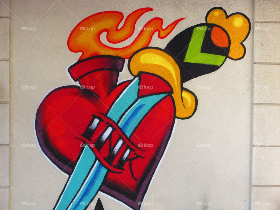 red heart with a dagger through it