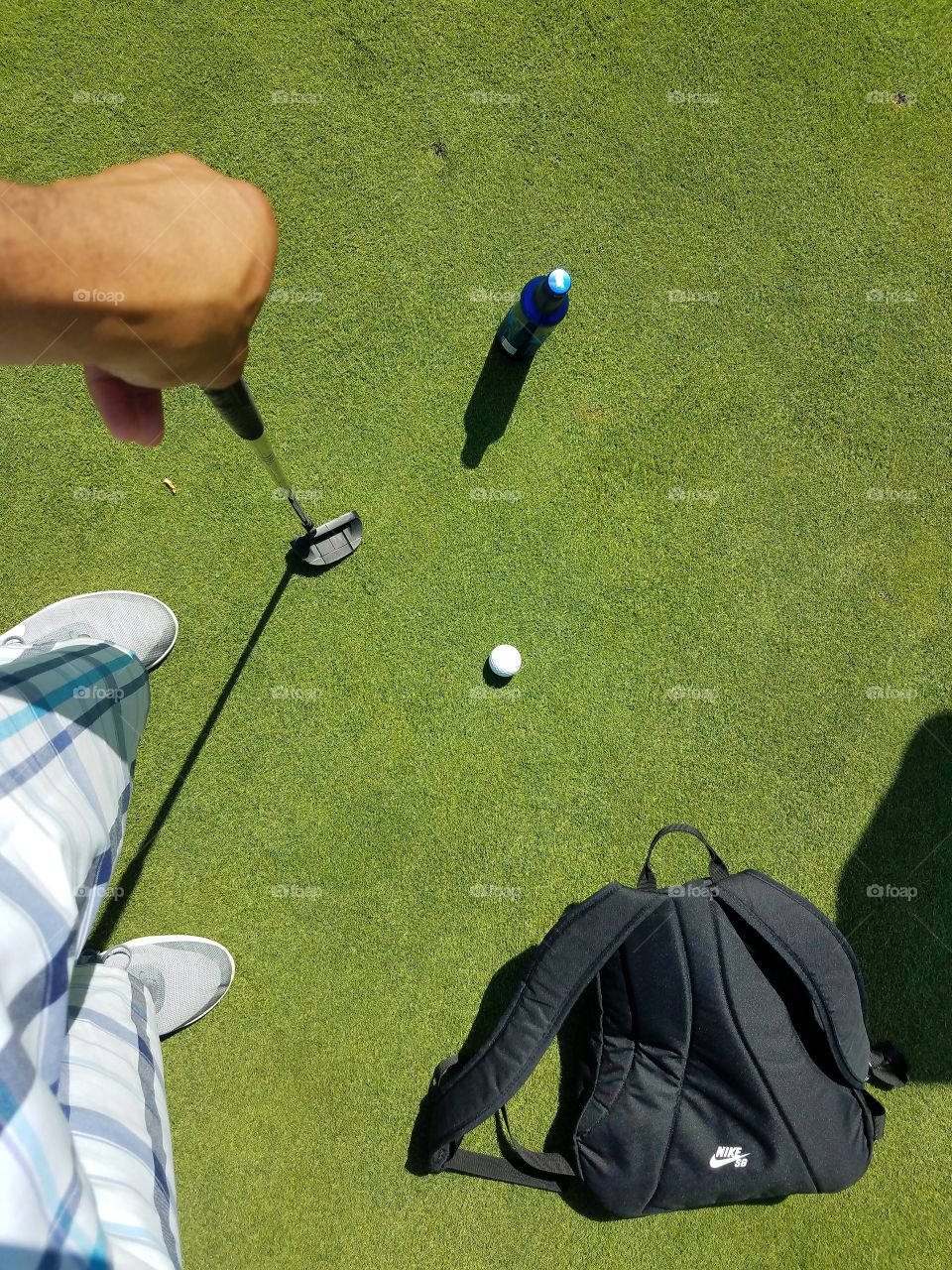 From way up, the pitch and put crew enjoy a day at the greens on a beautiful sunny day.