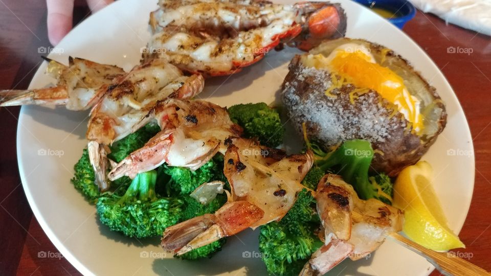 Grilled shrimp and loaded baked potato with broccoli
