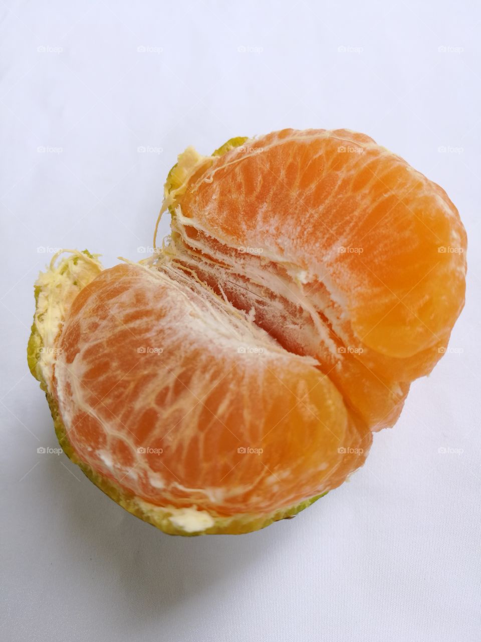 Closeup of peeled tangerine isolated on white background.