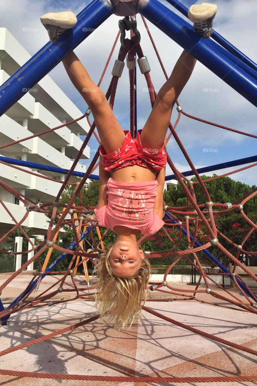 Girl hanging upside down