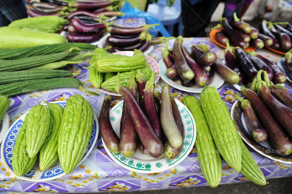 Eggplants sold along with Momordica charantia, known as bitter melon, bitter gourd, bitter squash, or balsam-pear, in local fresh market