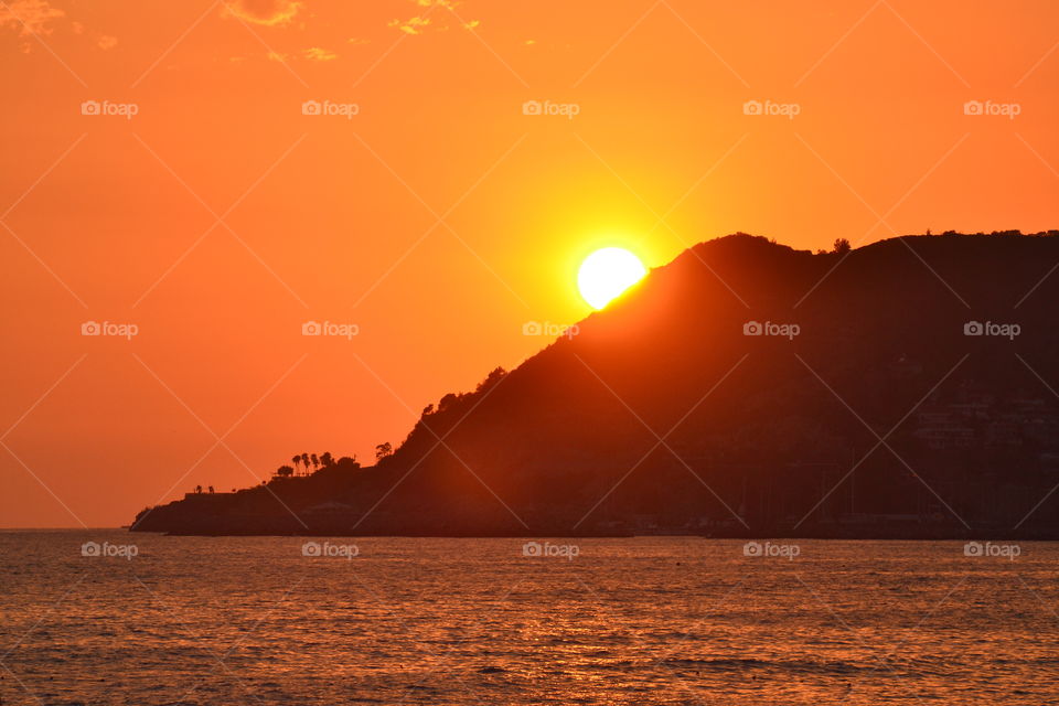 Sun behind the mountain at sunset