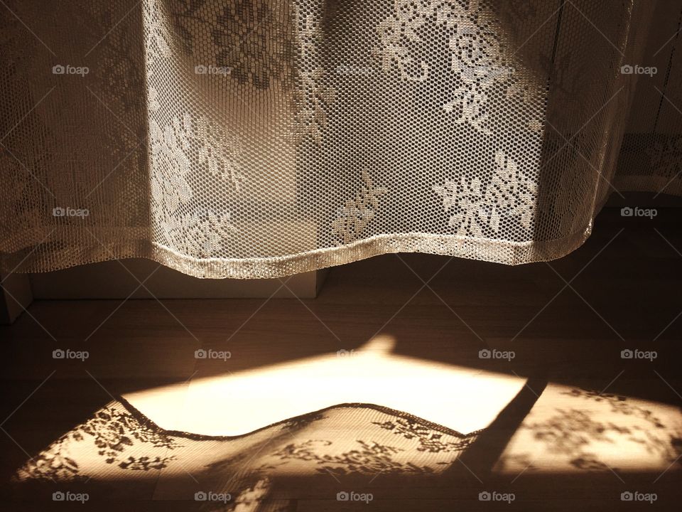 Elegant curtains with sunlight and shadows