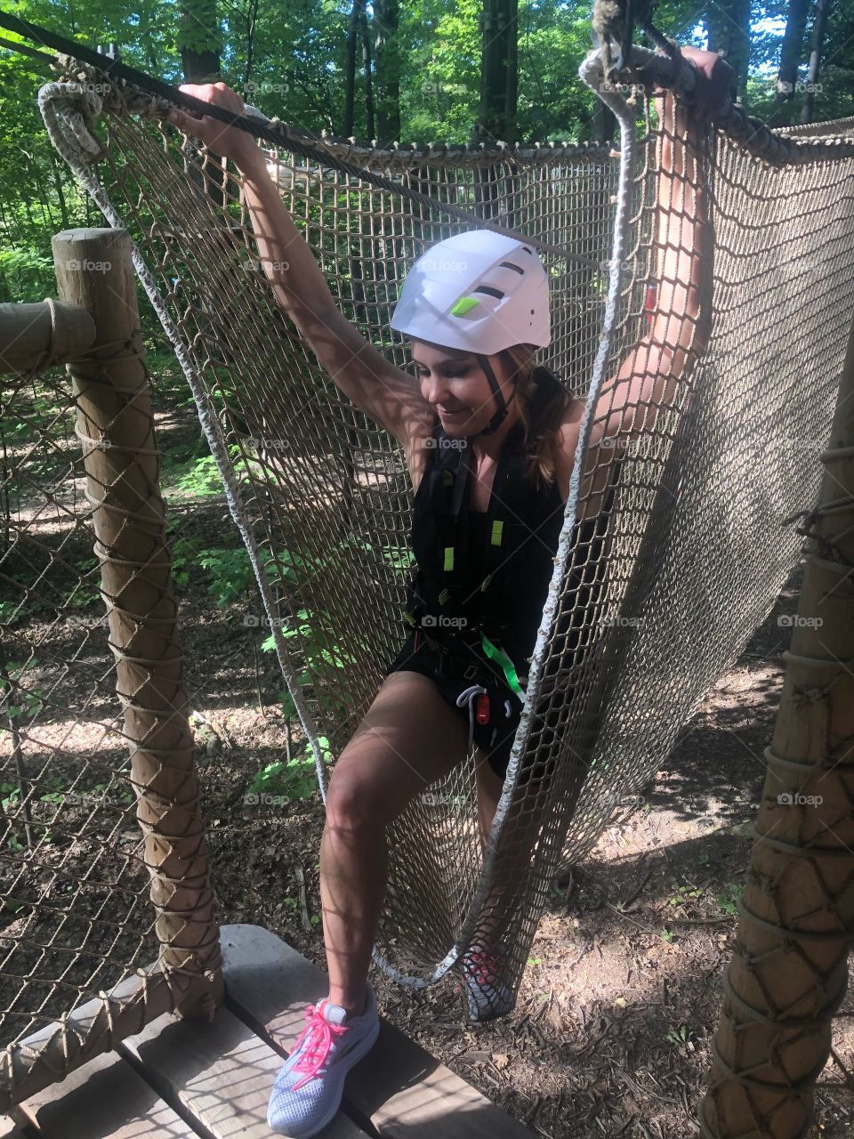 Woman climbing obstacle course