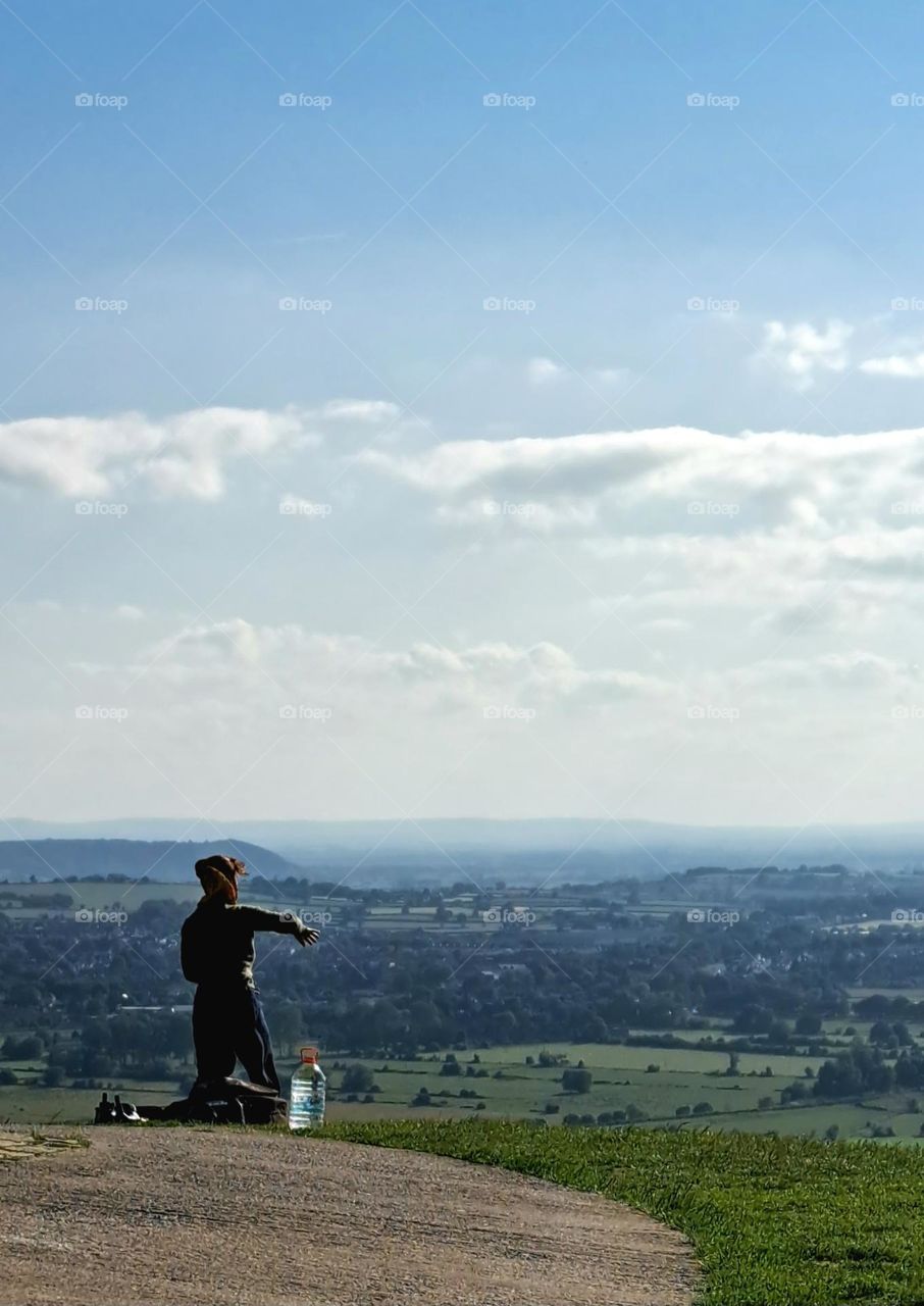 Capturing a lady doing meditation while taking a photo of the view  🧘‍♀️