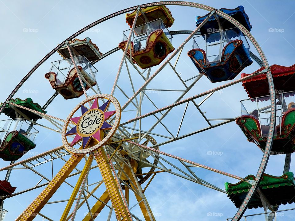 Ferris wheel at small fair in mall parking lot
