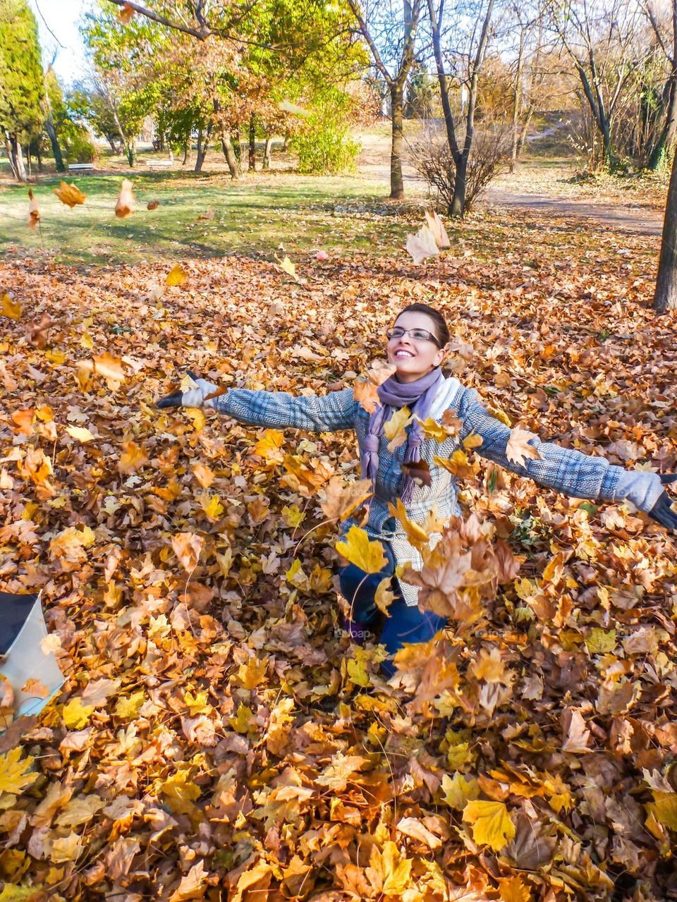 Woman sitting on autumn leaves