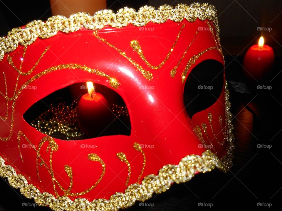 carnival mask and burning candle night view