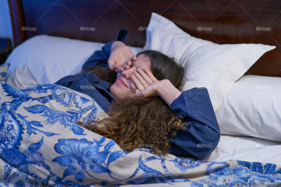 Woman waking up on bed