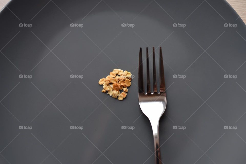 metal fork on a gray plate with oatmeal