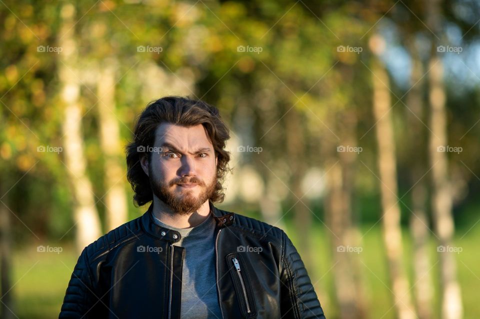 Young bearded man looking at camera