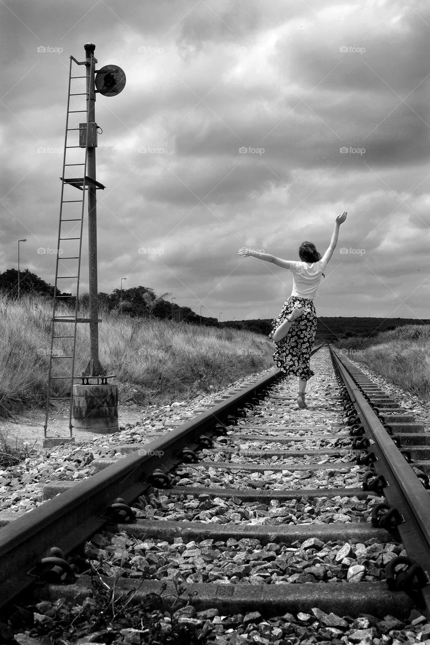 Railway track and dark grey sky