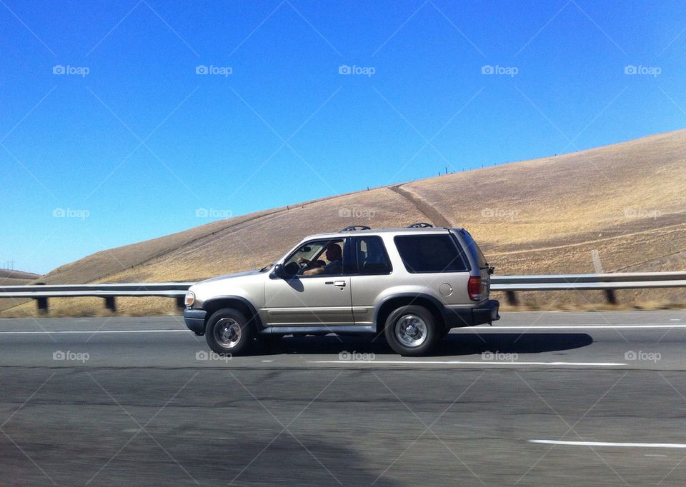 SUV on highway in desert