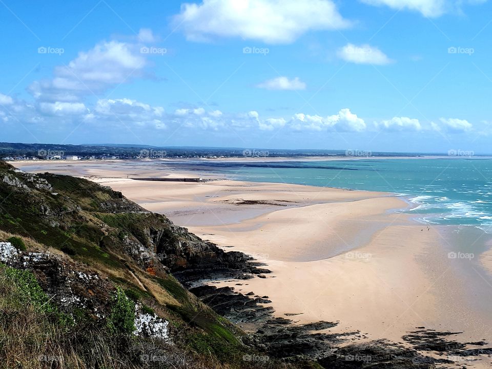 view of a beach and sea from the cliff