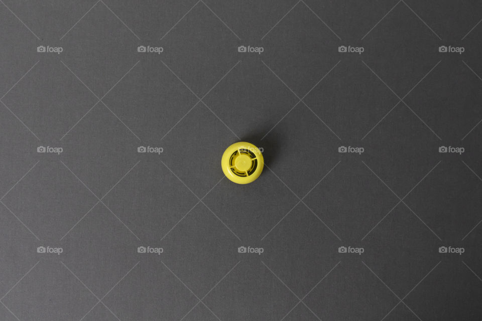small round yellow object on a gray background