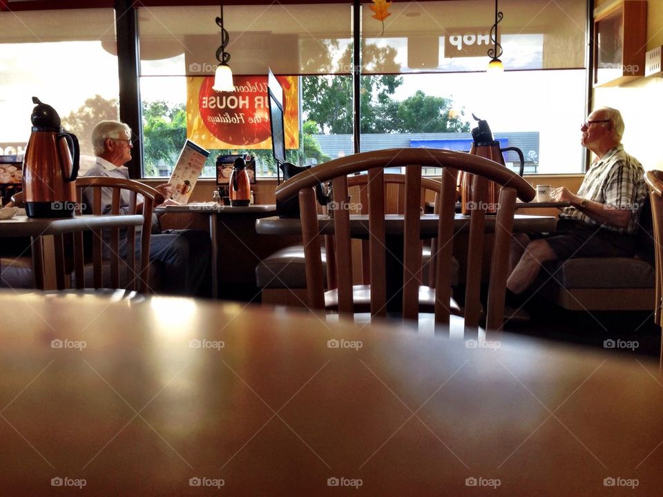 Man sitting in restaurant reading the menu