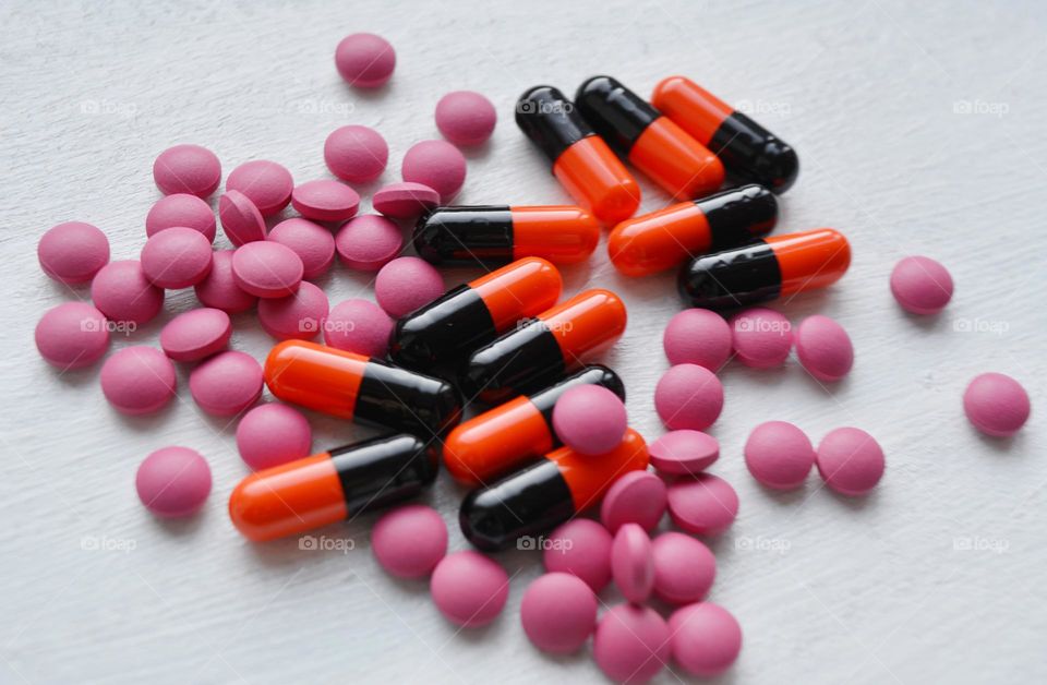 vitamins capsules and pills close up on a white background beautiful texture