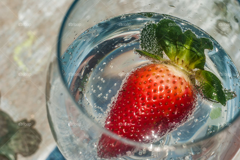 Close-up of strawberry in drinking glass