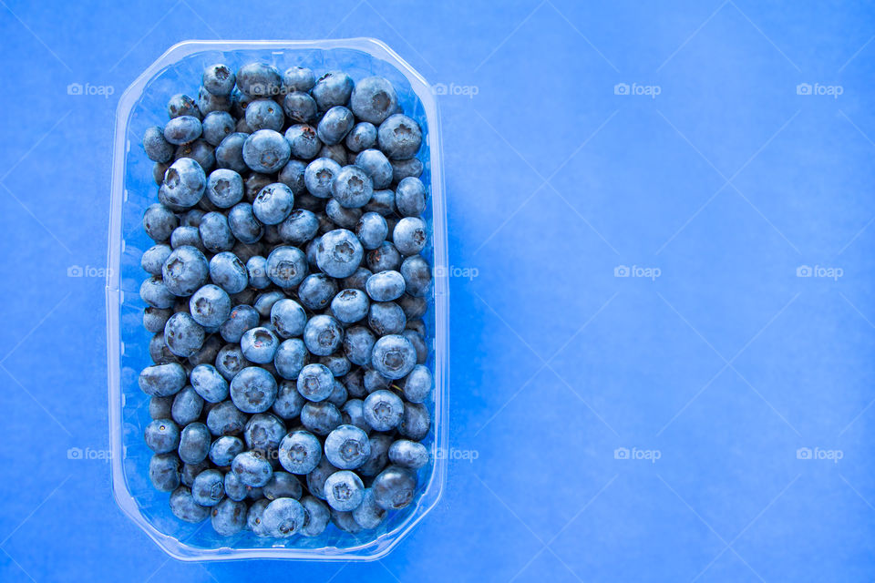 Fresh blueberries with blue background. Can be used for summer, food, nutrition, healthy, lifestyle, fresh themes