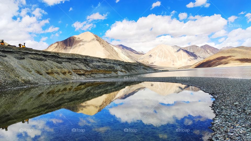 Incredible double seeing of mighty pink mounatins and running clouds in crystal clear water of Pangong tso- Ladakh, India. Massive level astounding landscape of 16km left me ecstatic and on cloud nine. Colour combo were enthrilling. Nature's asset😊.