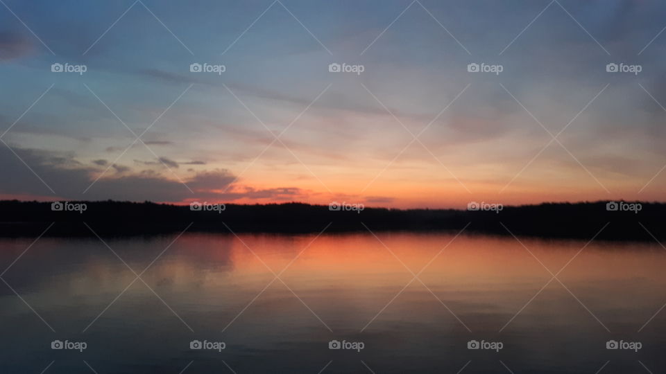 Red glowing sunrise over the lake