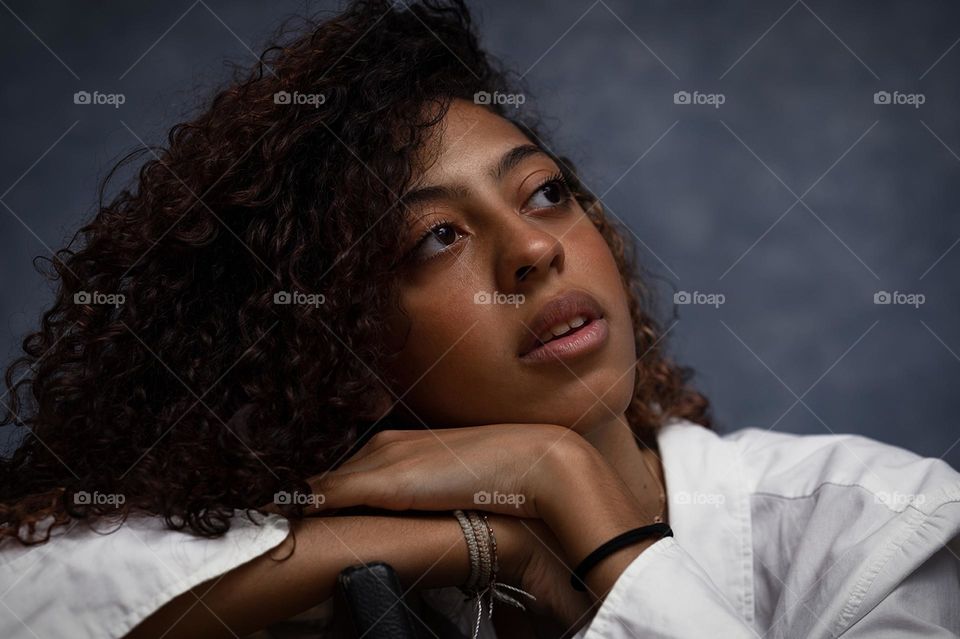 Portrait of a young dark-skinned girl with curly hair