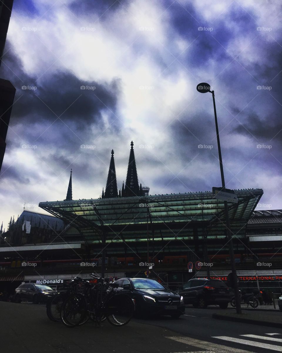 Railway station in Koln, and the majestic hights of the imposing dome rise above...