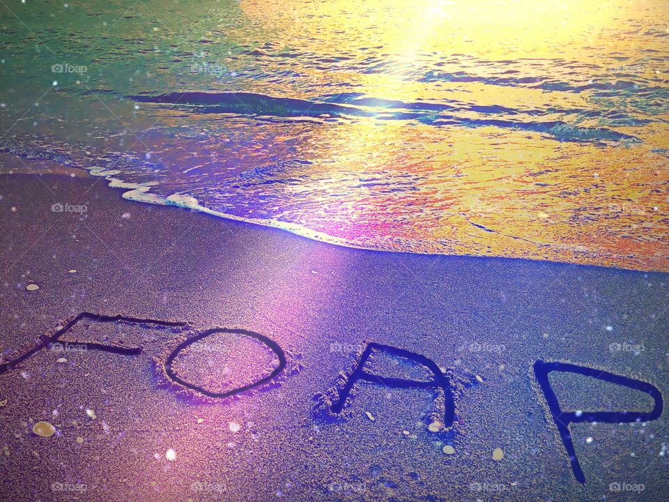 Foap Photography, shining Foap written in the sand.