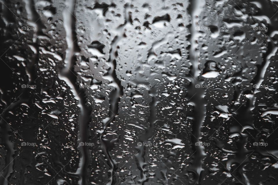 Droplets on a bus window glass, it was hard rain in a city and I love the texture and shape the droplets made