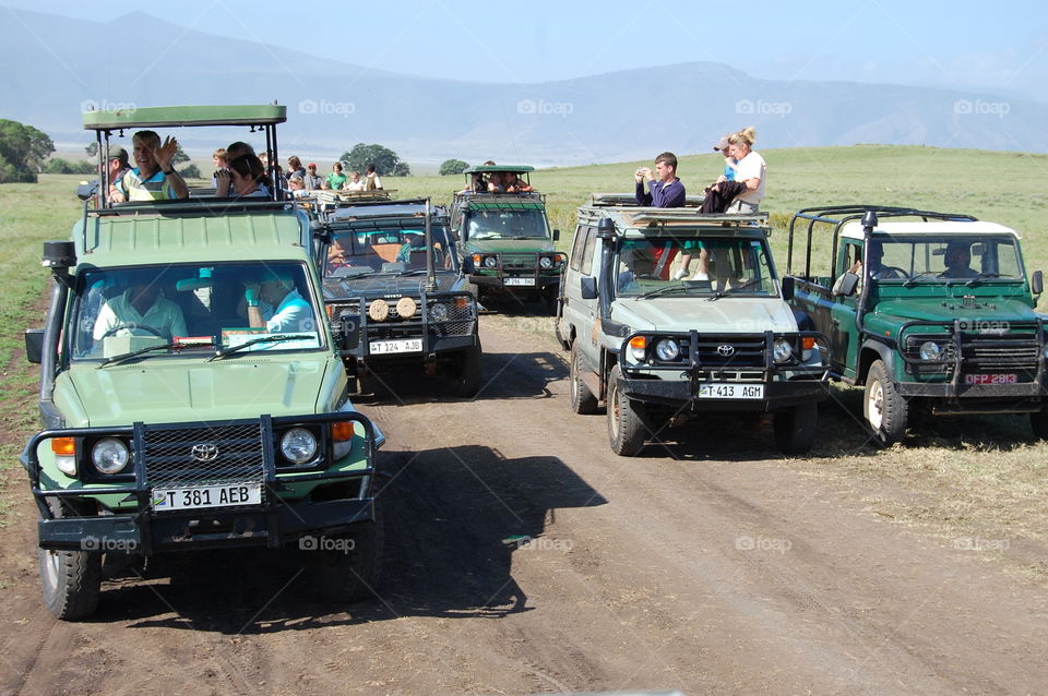 Tourist on Jeep safari in Serengeti National Park in Tanzania Africa.