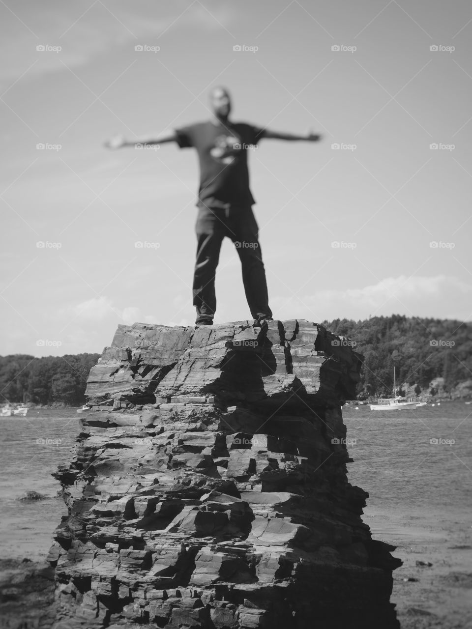 Happy grey story man on top of the rock