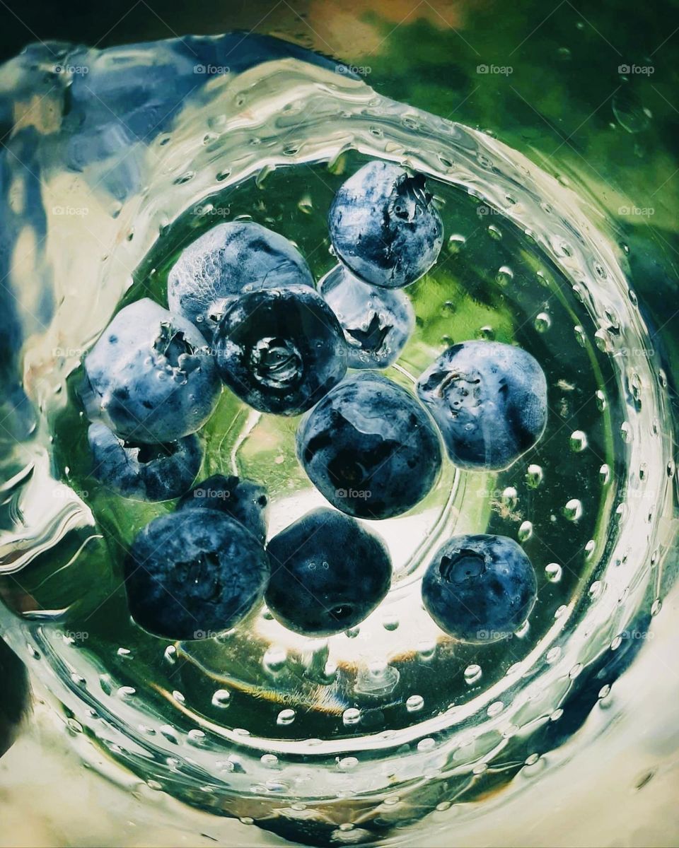 delicious juicy blueberries in a glass of water