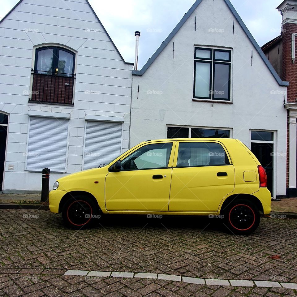 A car in the color yellow.