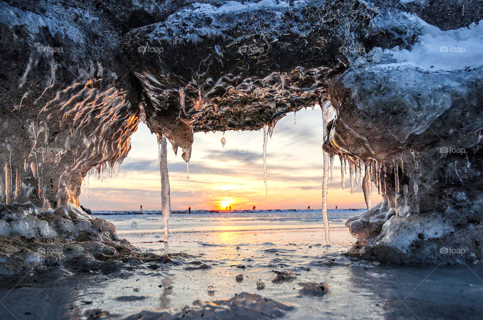 Winter sunrise over the frozen sea. Glamorous ice formations.