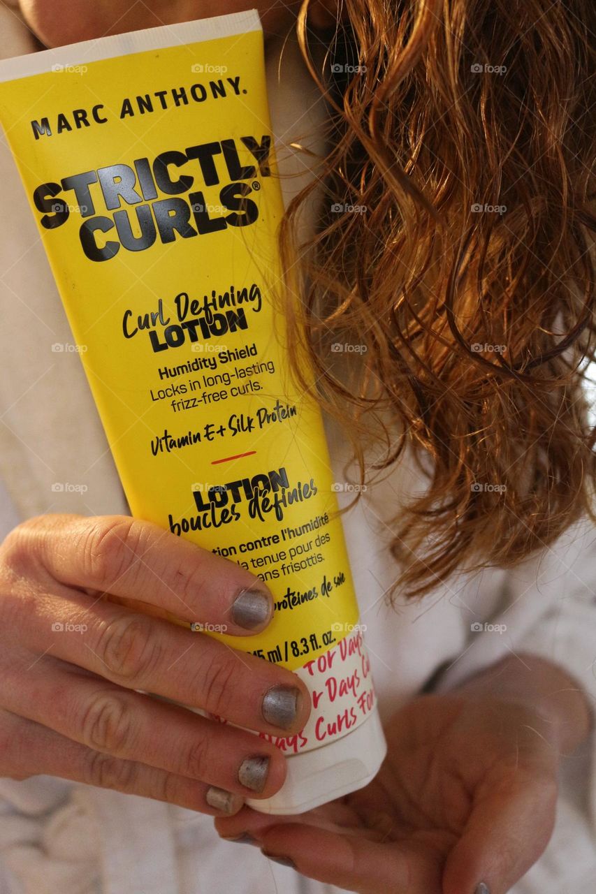 Applying Marc Anthony Strictly Curls curl defining lotion.