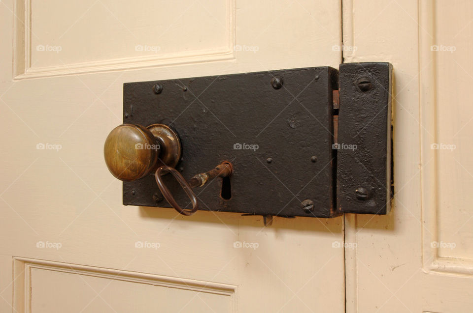 A key in the door of an old-fashioned doorknob