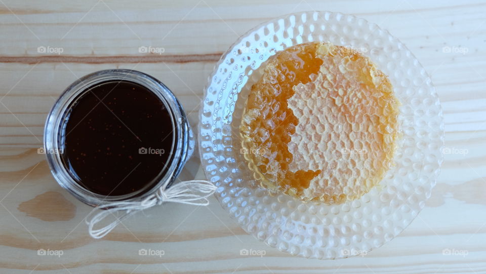 Jar of honey with honey comb