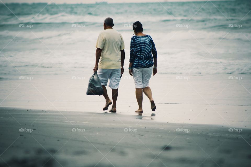 old age elder couple along the beach 