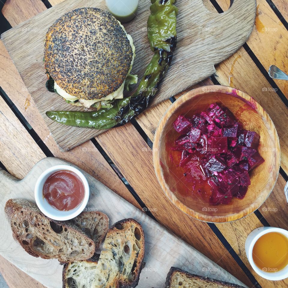 Hearth baked brunch. Vegetarian breakfast sandwich with kale, king oyster mushroom and scrambled egg and grilled hot pepper, red beets with pickled onion and feta, brown rice and vegetable hearth baked bread. 